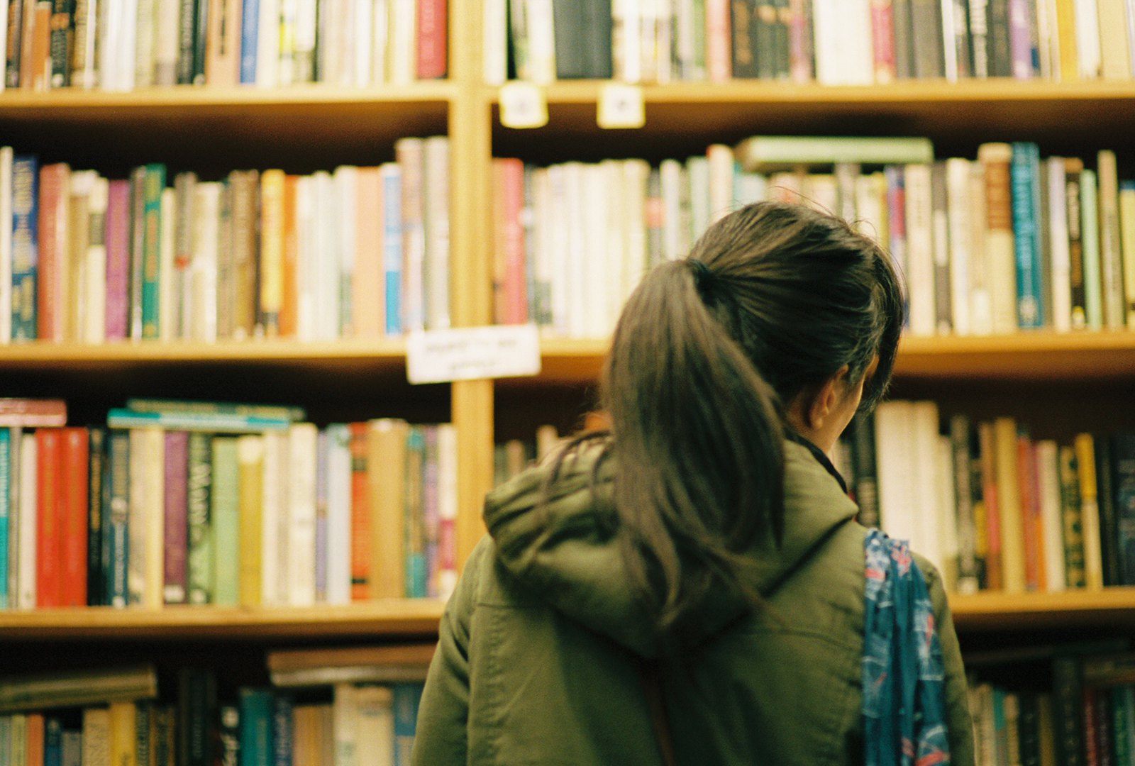 A girl peruses shelves of books