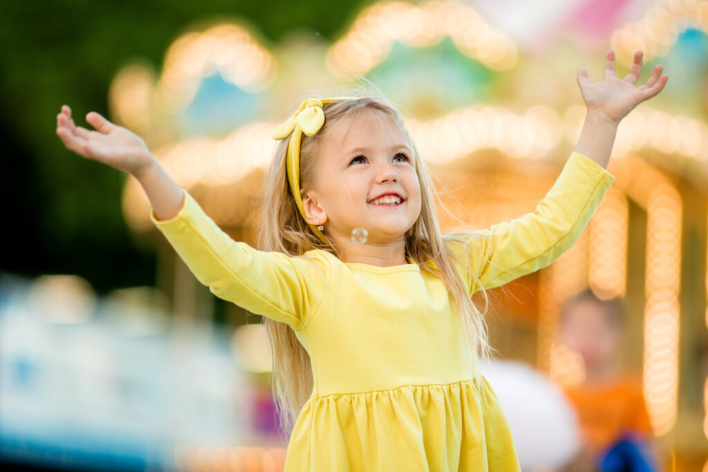 Little girl in yellow dress at Disneyland