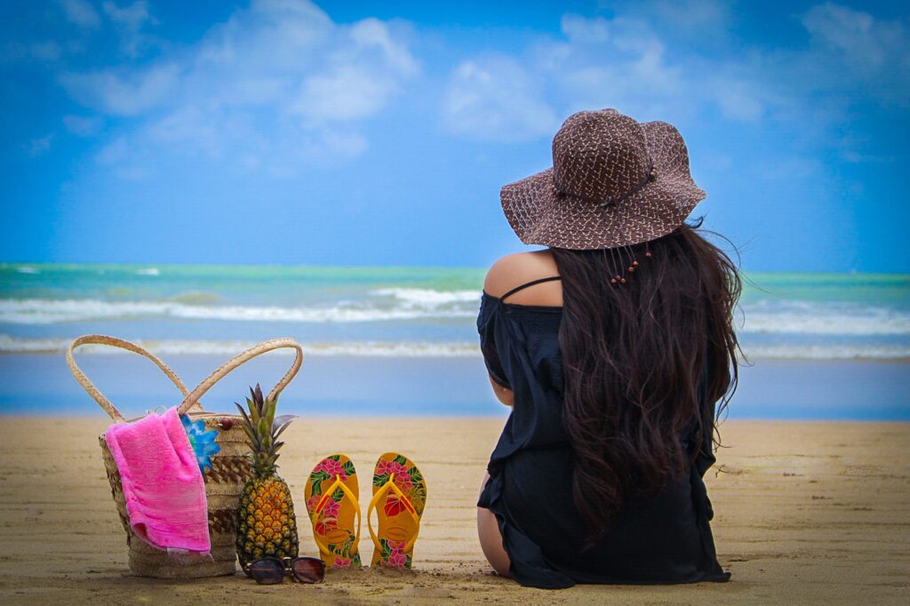 Woman on beach enjoying budget weekend getaway 