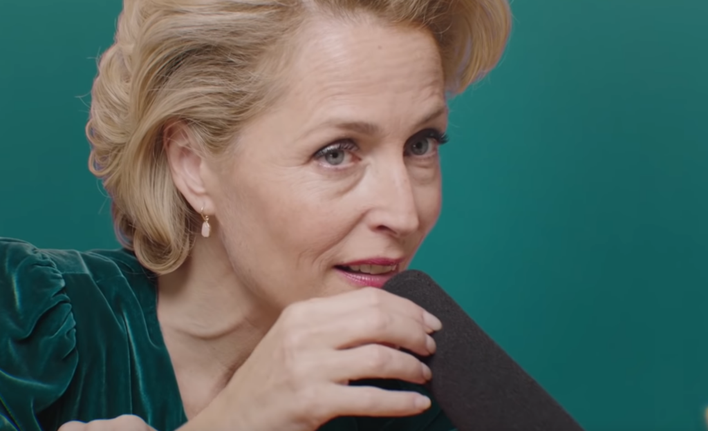 Sex Education's Gillian Anderson touching a microphone while doing ASMR