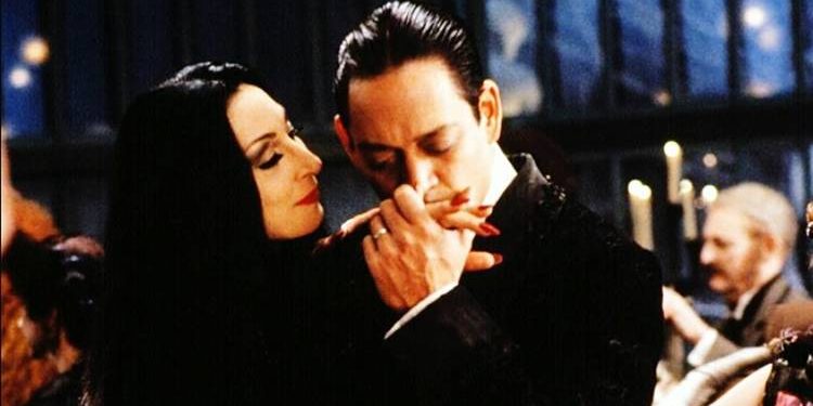 Gomez Addams kisses his wife Morticia's hand | gtg