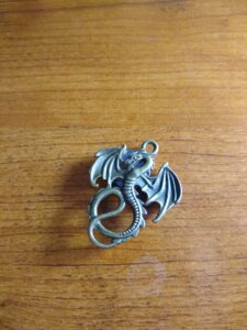 cross stitch needle minder shaped like a dragon