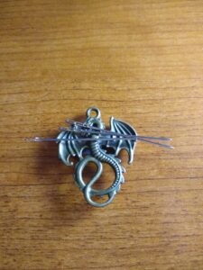 cross stitch needle minder shaped like a dragon