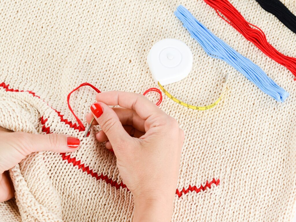 Hand cross stitching on fabric